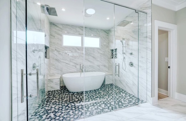 Bathroom Renovation Featuring Tub and Tiled Surround